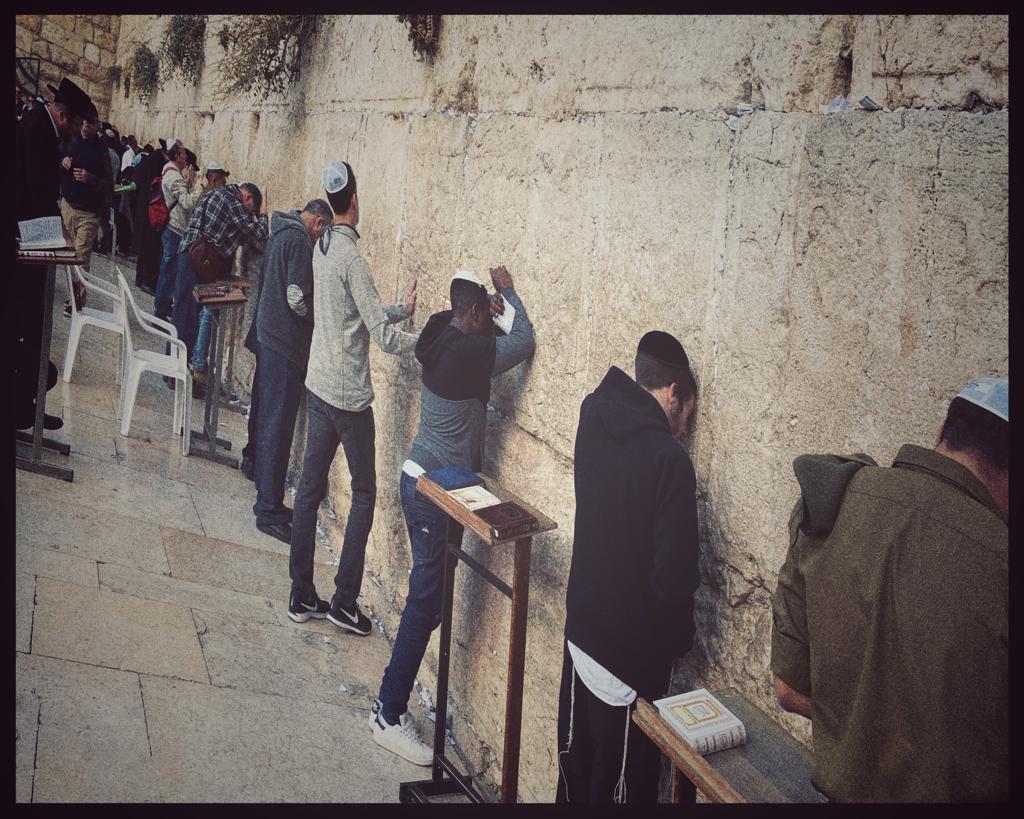 A group of people standing in front of a building

Description automatically generated